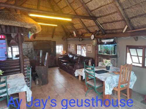 a living room with a couch and a table at Ay Jay's Guesthouse in Bloemfontein