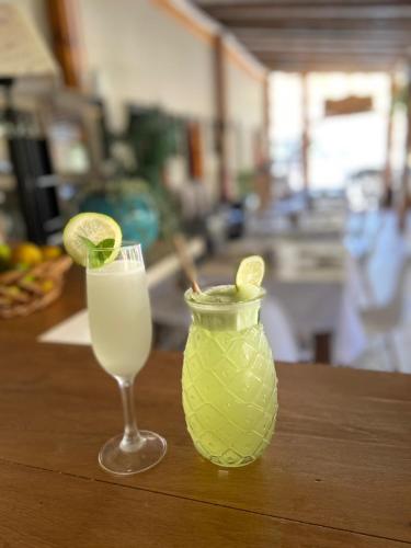 a glass of milk and a vase with a drink at Hotel El Tesoro de Elqui in Pisco Elqui