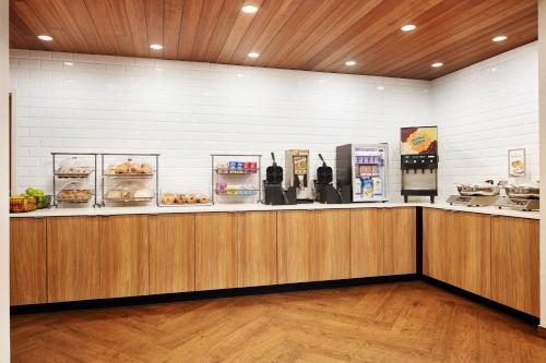 a restaurant with a counter with food on it at Fairfield Inn & Suites Worcester Auburn in Auburn