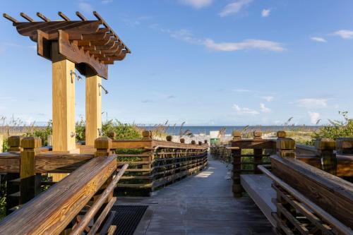 a row of wooden benches on the beach at Marriott's Barony Beach Club in Hilton Head Island