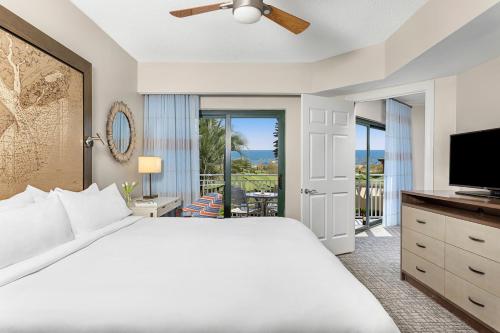 a bedroom with a bed and a flat screen tv at Marriott's Barony Beach Club in Hilton Head Island