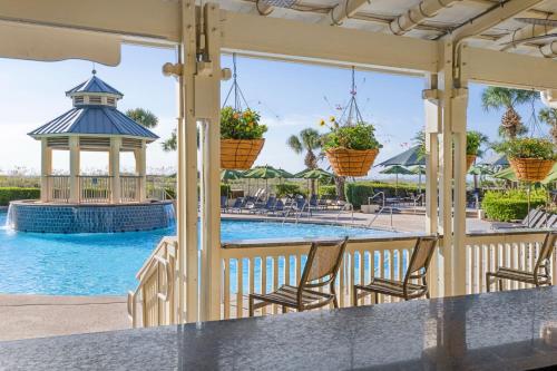 a view of the pool at a resort with chairs and a gazebo at Marriott's Barony Beach Club in Hilton Head Island