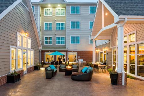 an outdoor patio with couches and chairs in front of a building at Residence Inn by Marriott Fargo in Fargo