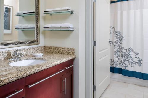 a bathroom with a sink and a mirror at Residence Inn by Marriott Fargo in Fargo