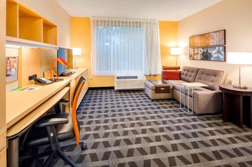 a hotel room with a couch and a desk in a room at TownePlace Suites by Marriott Bellingham in Bellingham