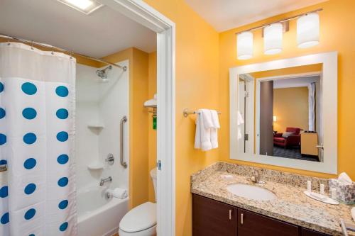 a bathroom with a sink and a toilet and a mirror at TownePlace Suites by Marriott Bellingham in Bellingham