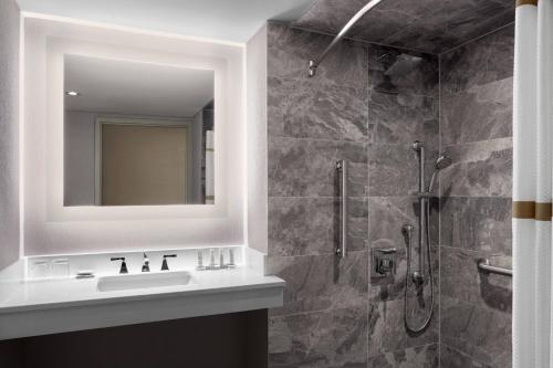 a bathroom with a sink and a shower at Niagara Falls Marriott Fallsview Hotel & Spa in Niagara Falls
