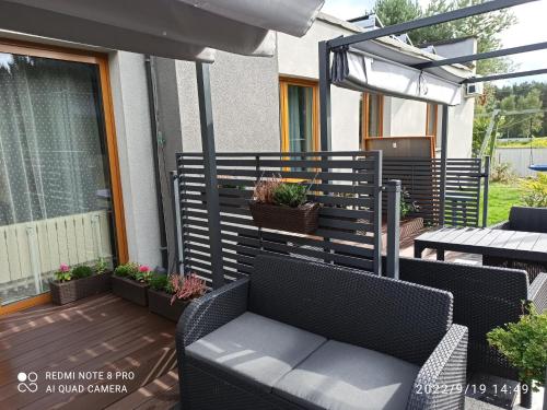 a patio with two chairs and a table with plants at 3-Studio in Poznań