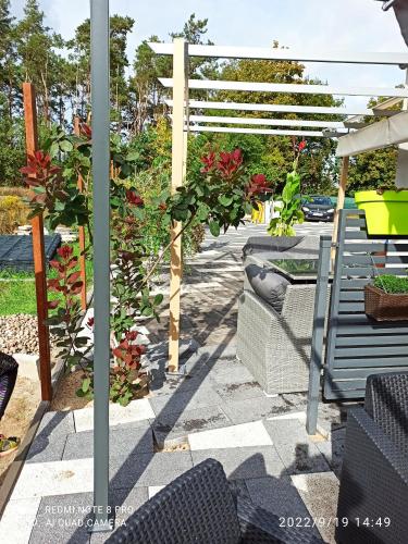 a patio with a bench and a pergola at 3-Studio in Poznań