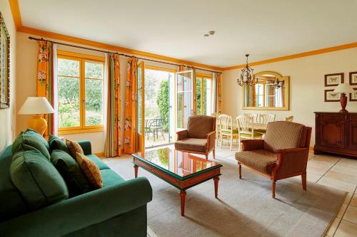 a living room with a couch and chairs and a table at Marriott's Village d'Ile-de-France in Bailly-Romainvilliers