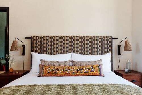 a bedroom with a bed with a large headboard at Downtown Los Angeles Proper Hotel, a Member of Design Hotels in Los Angeles