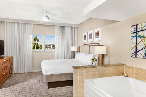 a hotel room with a bed and a tub at Marriott's Villas At Doral in Miami