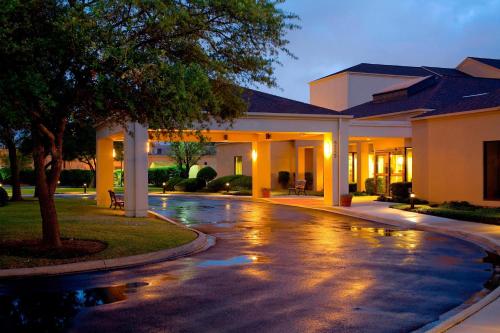a house with a rain soaked driveway at night at Courtyard by Marriott San Antonio Medical Center in San Antonio