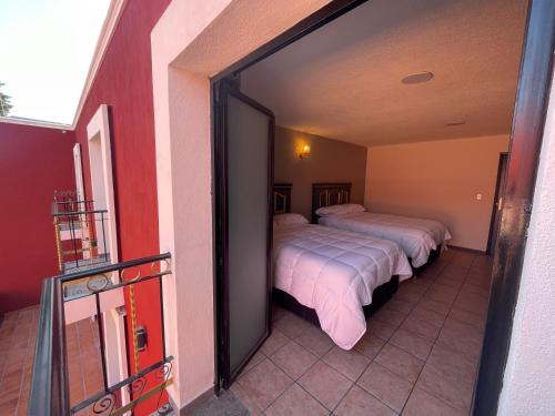 Postel nebo postele na pokoji v ubytování Hotel Casa Real Cholula
