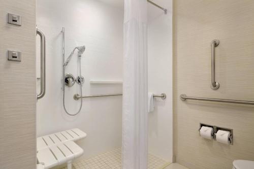 a bathroom with a shower with a sink and a toilet at Fairfield Inn & Suites by Marriott Lancaster East at The Outlets in Lancaster