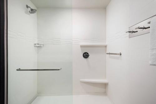 a white bathroom with a shower with a glass door at Residence Inn by Marriott Minneapolis St. Paul/Eagan in Eagan