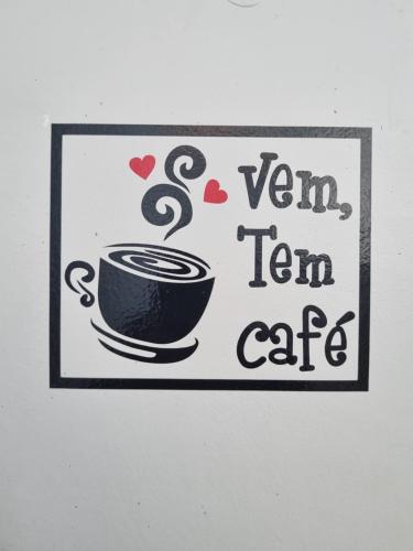 a sign with a cup of coffee on a wall at Portobello Hotel Orla in Santarém
