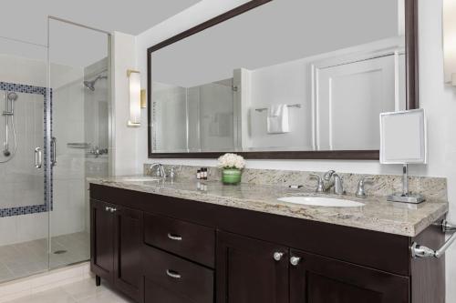 a bathroom with a sink and a large mirror at Marriott's Oceana Palms in Palm Beach Shores