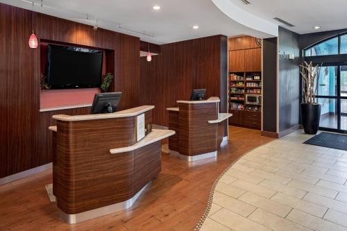 a hotel lobby with a tv and a reception desk at Courtyard by Marriott San Antonio SeaWorld®/Westover Hills in San Antonio