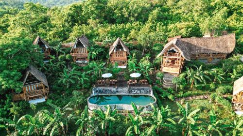 an aerial view of a resort with a swimming pool at Penida Bambu Green Suites in Nusa Penida