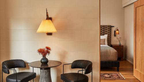 a room with a table and chairs and a bed at Downtown Los Angeles Proper Hotel, a Member of Design Hotels in Los Angeles