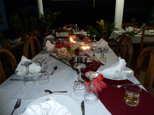 a table with wine glasses and candles on it at Tannette Villa in La Digue