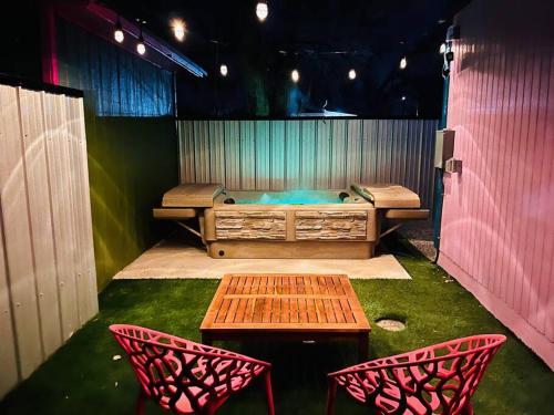 a stage with two chairs and a table and a bench at Agave Tiny House at Cactus Flower-HOT TUB-Pet Friendly-No Pet Fees! in Albuquerque