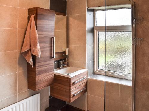 a bathroom with a sink and a shower at Linden Cottage in York