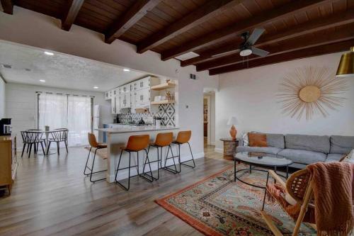 a living room with a couch and a table and chairs at Casa Charleston-3BR-2Bath-Private HOT TUB-Pet Friendly-No Pet Fees! in Albuquerque