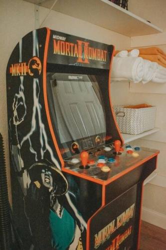 a room with a video game machine with a mirror at Casa Charleston-3BR-2Bath-Private HOT TUB-Pet Friendly-No Pet Fees! in Albuquerque