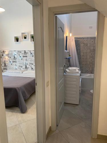 a bedroom with a bed and a sink and a tub at Casa Major in Maiori