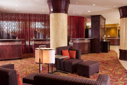 a hotel lobby with chairs and a bar at Greenville Marriott in Greenville