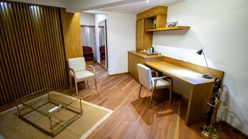 a room with a desk and two chairs and a lamp at Salta Suite in Salta