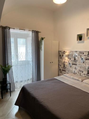 a bedroom with a large bed and a window at Casa Major in Maiori