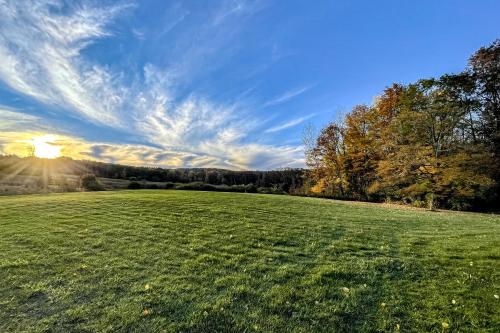 a large green field with the sun in the sky at McKenzie Highlands in Watkins Glen