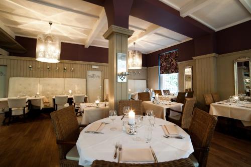 a dining room with white tables and chairs at Hotel La Tonnellerie in Spa