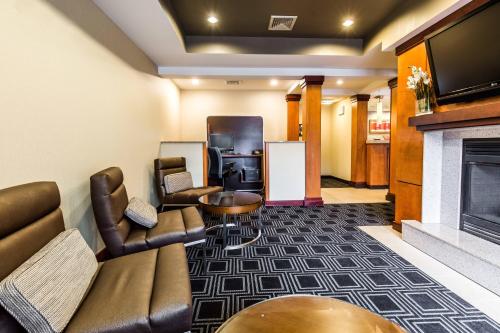 a hotel room with a couch and a fireplace at TownePlace Suites by Marriott Gilford in Gilford