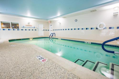 a large swimming pool with a pool noodle in a building at TownePlace Suites by Marriott Gilford in Gilford