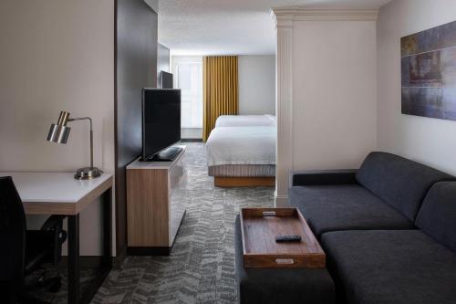 a living room with a couch and a bed at SpringHill Suites by Marriott New Orleans Warehouse Arts District in New Orleans
