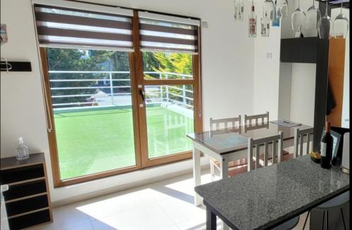 a kitchen with a large window with a view of a tennis court at Comfortable apartment and excellent location in Ushuaia