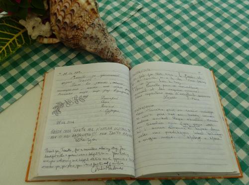 an open book sitting on top of a table at Tannette Villa in La Digue