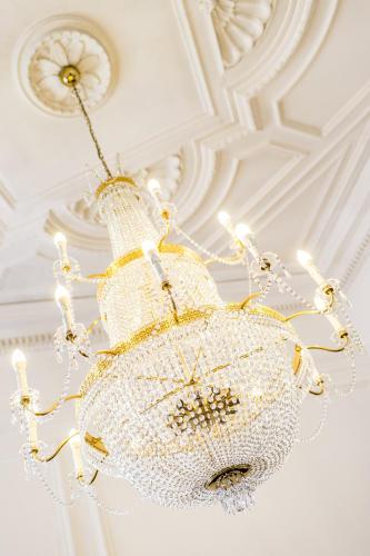 a chandelier hanging from a ceiling in a room at Grand Hotel Bellevue - adults only in Merano
