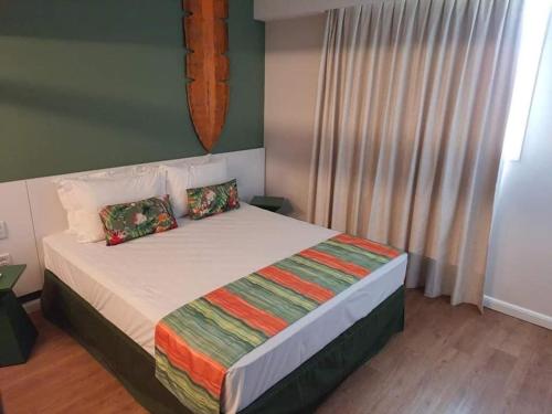 a bedroom with a large bed in a room at Hot Beach Suites Olimpia Resort in Olímpia