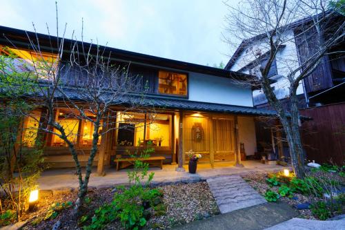 a house with a fire hydrant in front of it at Ryoan Fukinotou in Bungotakada