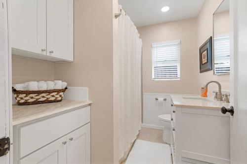 a white bathroom with a sink and a toilet at Large Kitchen Near Shops Easy Highway Access in Chico