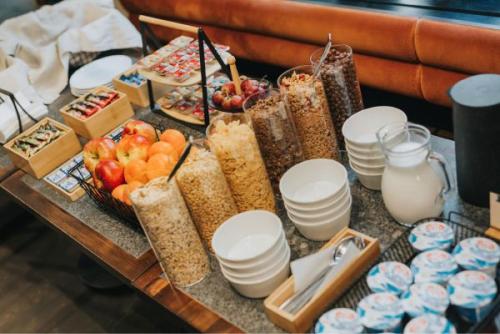a table filled with different types of food at Apartament Szyfonowy by Good Time in Łódź