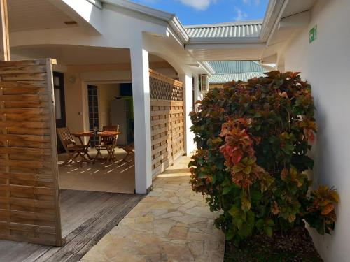 a porch with a fence and a plant at Vacances martinique in Sainte-Anne
