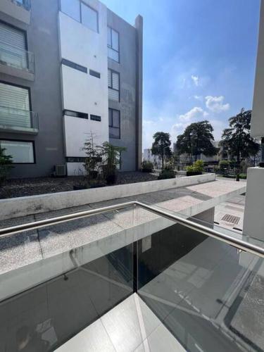 a building with a glass walkway in front of a building at Precioso departamento cerca de Plaza Galerías in Guadalajara
