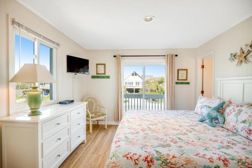a bedroom with a bed with a dresser and a window at Armstrong in Surf City