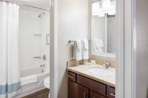 a bathroom with a sink and a toilet and a mirror at TownePlace Suites Tempe at Arizona Mills Mall in Tempe